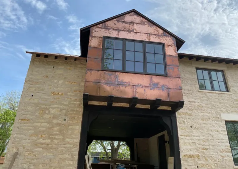 Copper metal panel facade on a stone building for Skylight Installation in Orchard Homes